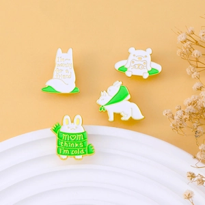 Set of four cute animal enamel pins with rabbit and fox on a decorative warm display