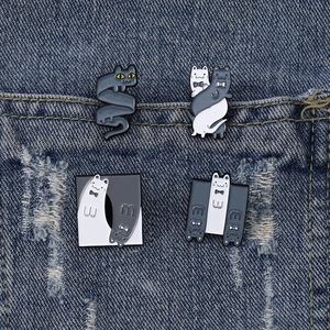 Set of four cartoon yoga cats enamel pins on denim fabric showing various cat poses