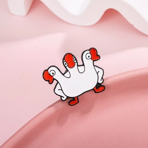 Whimsical three-headed white goose enamel brooch pin with red accents and cartoon style
