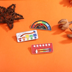 Three creative social mood enamel pins with adjustable battery and meter designs on orange backdrop