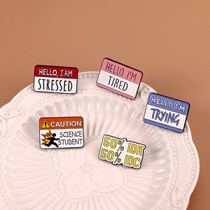 Creative enamel badge set with fun emotion quotes on a textured white plate