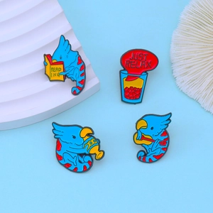 Set of four creative blue bird enamel pins featuring reading and guitar themes