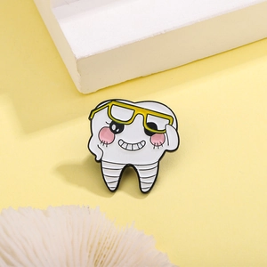 Creative cartoon tooth enamel pin with glasses on a yellow minimalist background