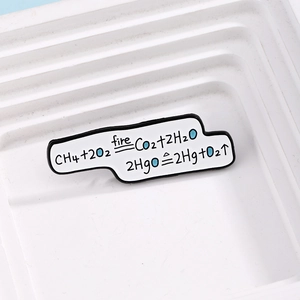 Detail of creative chemistry enamel pin showing methane and mercuric oxide formulas