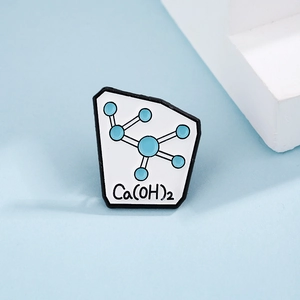 Creative chemistry enamel pin featuring a blue molecule model and Ca(OH)2 formula design