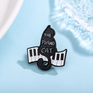 Creative enamel brooch featuring a black cat playing piano keys with The Piano Cat text