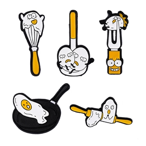 Creative food-themed egg brooch set featuring fried egg pan and whisk cartoon accessories