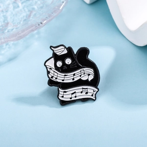 Cartoon black cat enamel brooch with musical notes and piano keys on light blue background