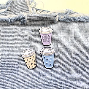 Three-piece set of creative enamel coffee cup pins pinned on blue denim fabric