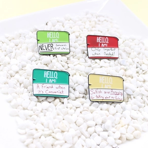 Set of four colorful enamel lapel pins styled as name tags on white stones