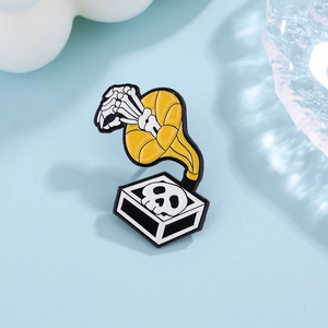 Punk skeleton hand with record player enamel brooch on blue decorative background