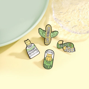 Set of four creative enamel pins featuring cat toothpaste and medicine capsule designs