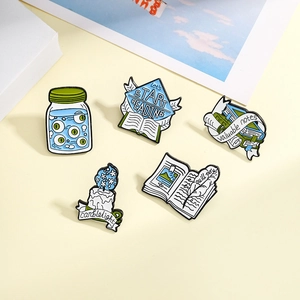 Five-piece creative enamel pin set with magic book, candle, and quill reading theme