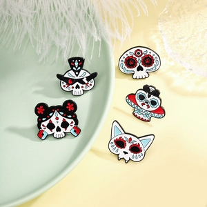 Five creative Day of the Dead enamel pins featuring skull and cat mask designs