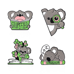 Set of four cute koala enamel pins reading books and sleeping on a white background