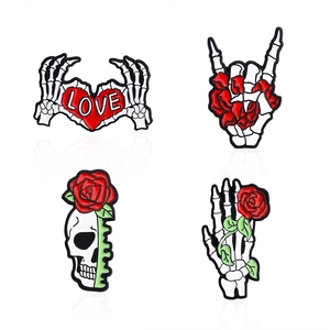 Gothic punk enamel pin set featuring skull heart gesture and rose skull designs
