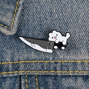 Creative cartoon puppy enamel pin carrying a fruit knife on blue denim fabric