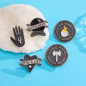 Set of five black enamel pins featuring coffee cup, axe, and let's seek letter designs