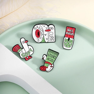 Set of four creative cartoon duck enamel pins featuring bandage and nail polish themes