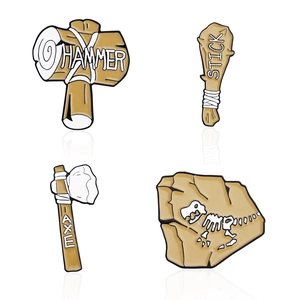 Cartoon dinosaur fossil archaeology enamel pins set featuring stone hammer and axe tools