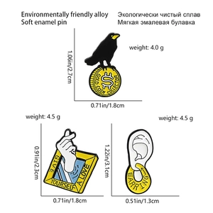 Detailed view of enamel pins set with heart gesture and crow motifs in eco alloy