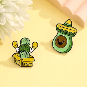 Cute avocado in sombrero and boxing cactus enamel pins set on a warm background