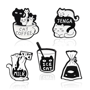 Set of 5 minimalist black and white enamel cat pins featuring playful feline designs
