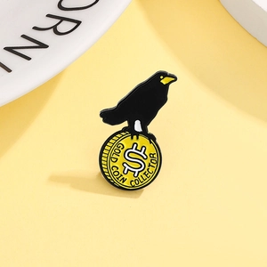 Artistic enamel crow brooch with a gold coin collector design on a yellow background