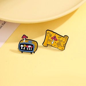 Retro TV and magic scroll enamel pins featuring colorful mushroom and mystic star designs