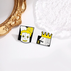Detailed close-up of Joker and King enamel pins with intricate cartoon poker card designs