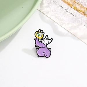 Macro detail of cartoon purple plant enamel pin with a large eye and white wing detail