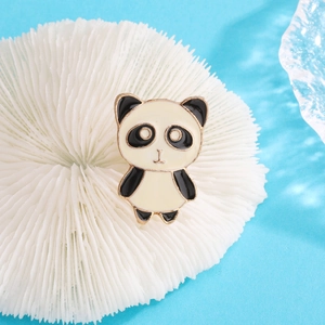 Cute panda enamel brooch with black and white finish on a bright blue background