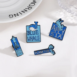 Set of four blue ocean creature enamel pins featuring whale, cuttlefish and plankton