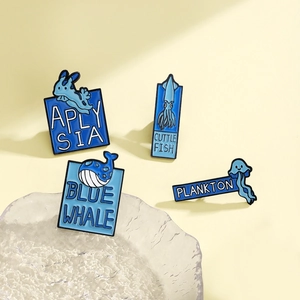 Nautical enamel pin set featuring blue whale, squid, sea hare, and plankton designs