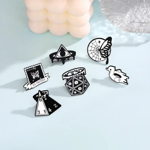 Minimalist black and white enamel brooch set featuring butterfly, duck, and geometric designs