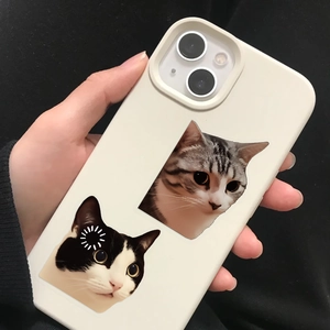 Close-up of cream-colored iPhone case featuring cute realistic cat prints held in hand