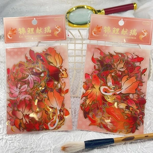 Close-up of decorative koi fish stickers with gold foil details for journals and scrapbooks