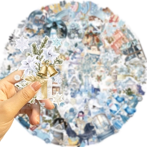 Close-up of winter watercolor stickers with snowflakes and bells for journal decoration