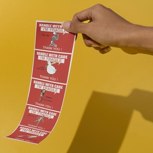 Macro detail of humorous red shipping labels with funny graphics and fragile warnings