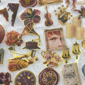 Macro shot of vintage court style PET stickers with gold foil edges and retro designs