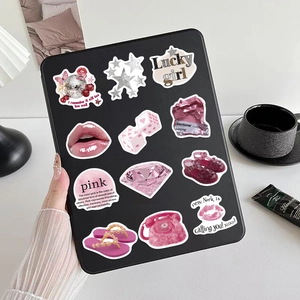 Détails d'autocollants roses esthétiques downtown posés sur une tablette noire