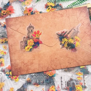 Retro hand-drawn floral and world landmark stickers on a vintage paper envelope