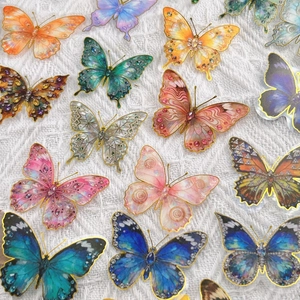 Macro view of colorful butterfly stickers with gold foil edges and sparkling textures