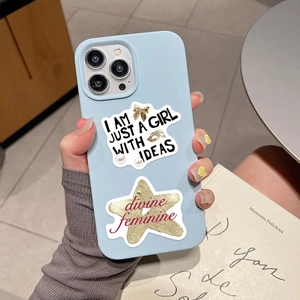Detail of light blue iPhone case with I AM JUST A GIRL WITH IDEAS and divine feminine stickers