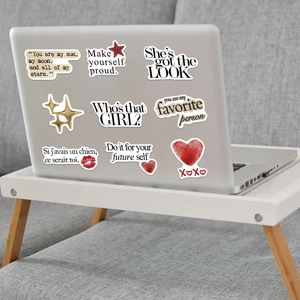 Detail of waterproof Silver Lucky Girl stickers applied to a silver laptop cover