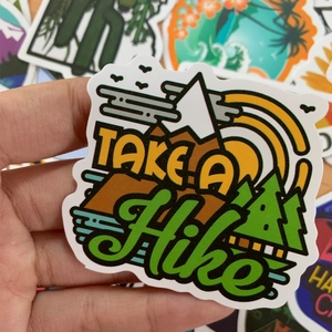 Detail shot of waterproof Take A Hike sticker for outdoors travel and adventure gear
