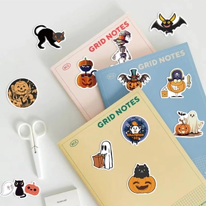 100pcs waterproof Halloween stickers featuring pumpkins, ghosts, and cats on colorful notebooks