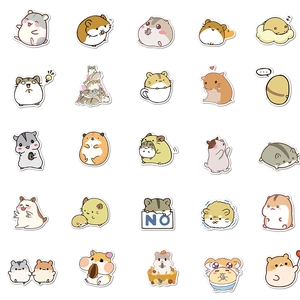Flat lay of 25 cute cartoon hamster stickers in a neat 5x5 grid for laptop and luggage