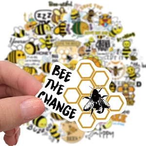 Detail of Bee The Change waterproof PVC sticker featuring golden honeycomb patterns