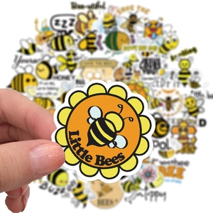Handheld view of 50pcs waterproof cartoon bee stickers for laptop and luggage decor